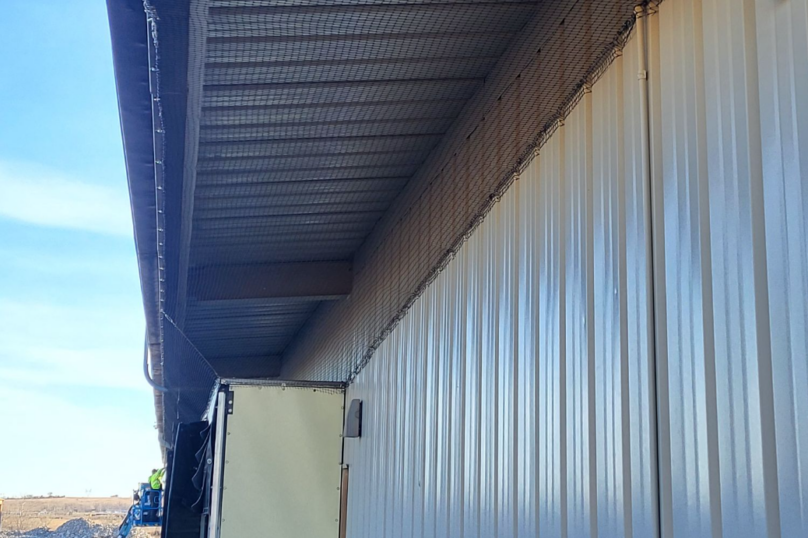 Protective net system installed in a building worksite to prevent bird intrusion