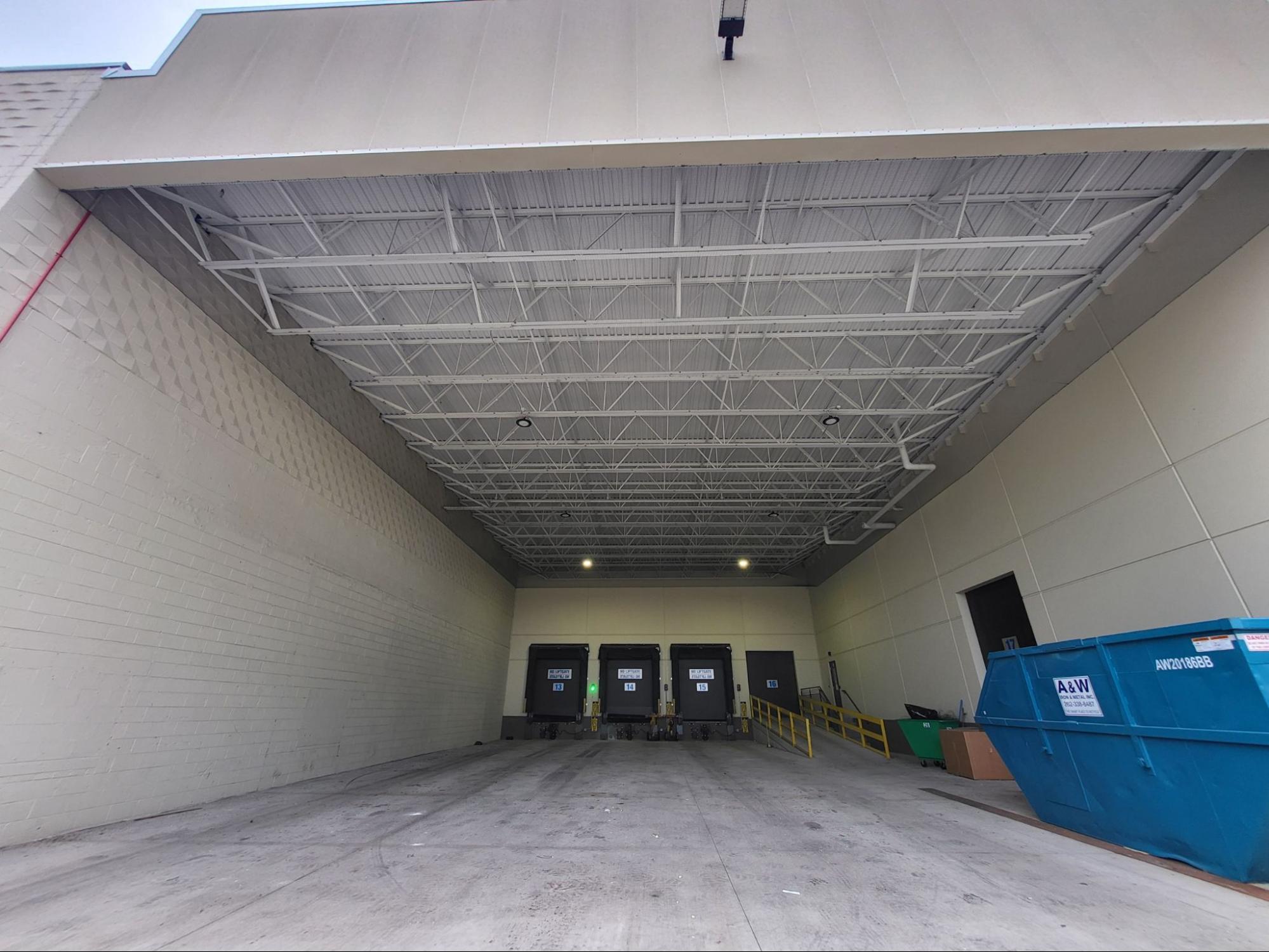Bird netting installed over a warehouse service entry to prevent bird access